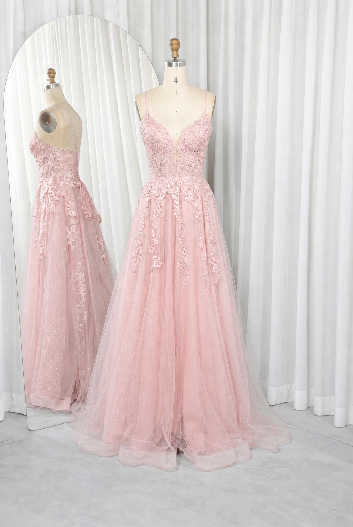 Pink A-line prom dress with lace bodice, spaghetti straps, and tulle skirt