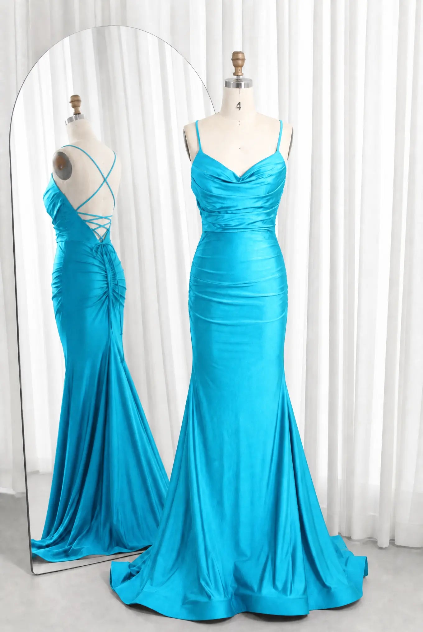 Turquoise satin cowl-neck ruched mermaid prom dress with spaghetti straps and flared hem.
