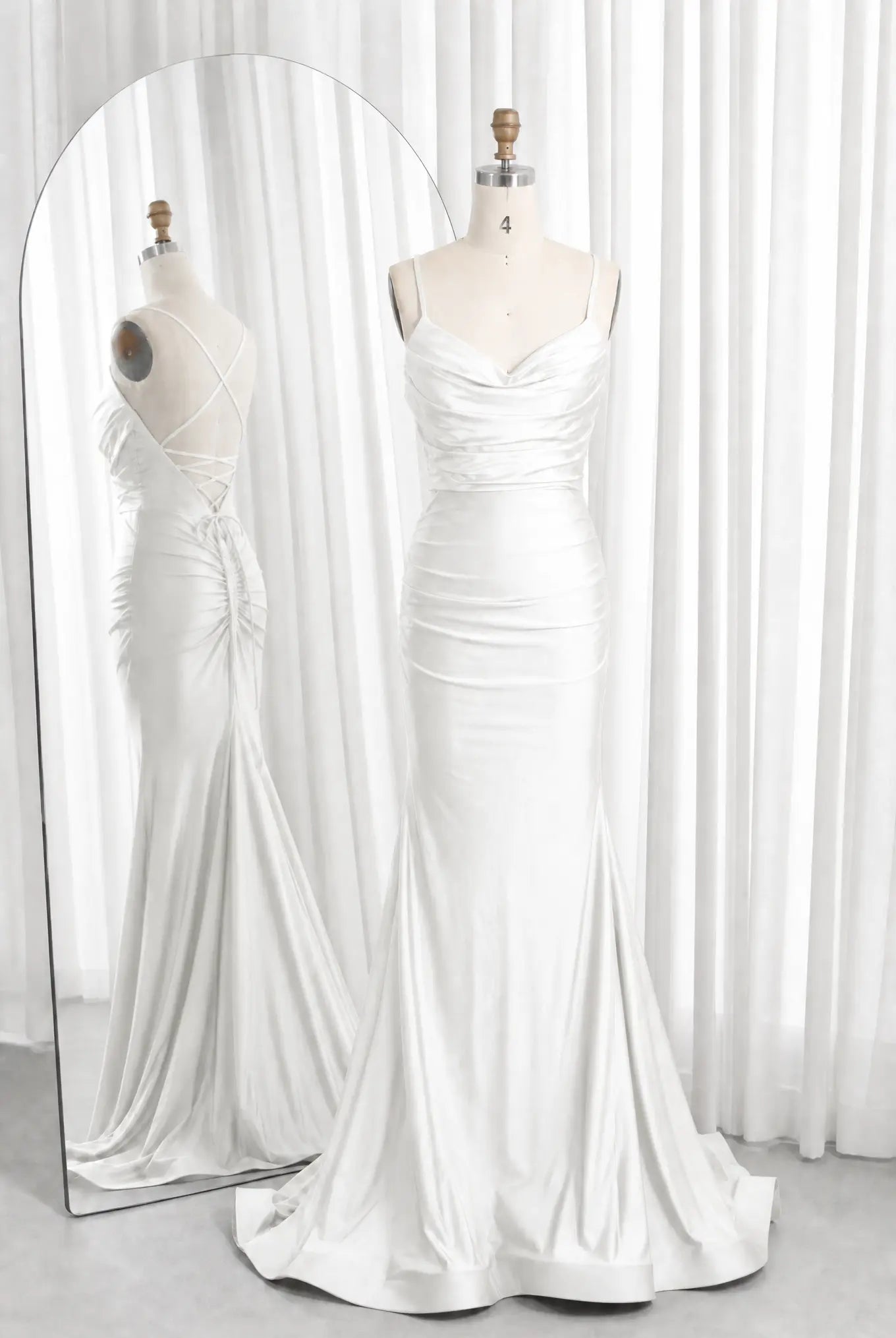 White satin cowl-neck ruched mermaid prom dress with spaghetti straps and flared hem.
