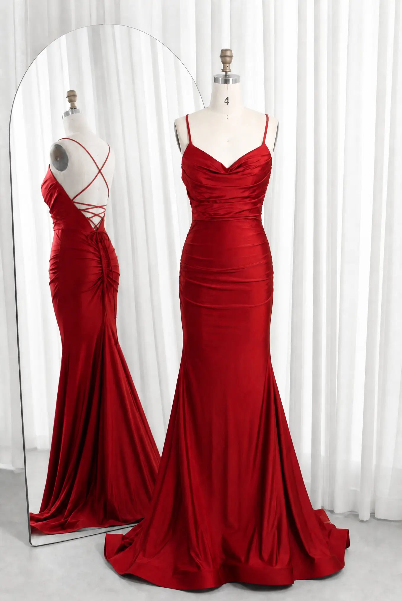 Red satin cowl-neck ruched mermaid prom dress with spaghetti straps and lace-up back.