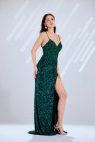 Emerald green sequin evening dress with spaghetti straps, V-neck, and side slit