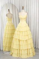Yellow strapless tiered ruffle ball gown with corset-style bodice, layered skirt.