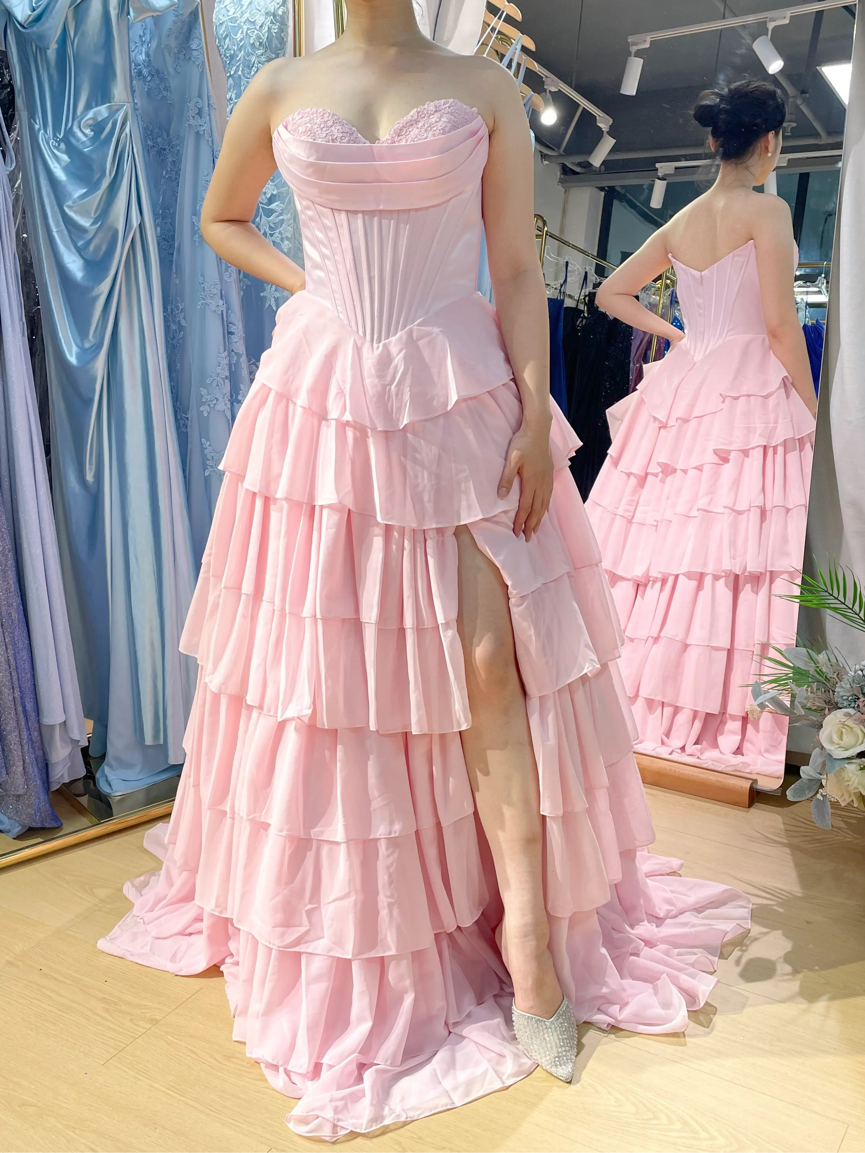 Structured corset tiered ruffle ball gown in light pink with sweetheart lace neckline.