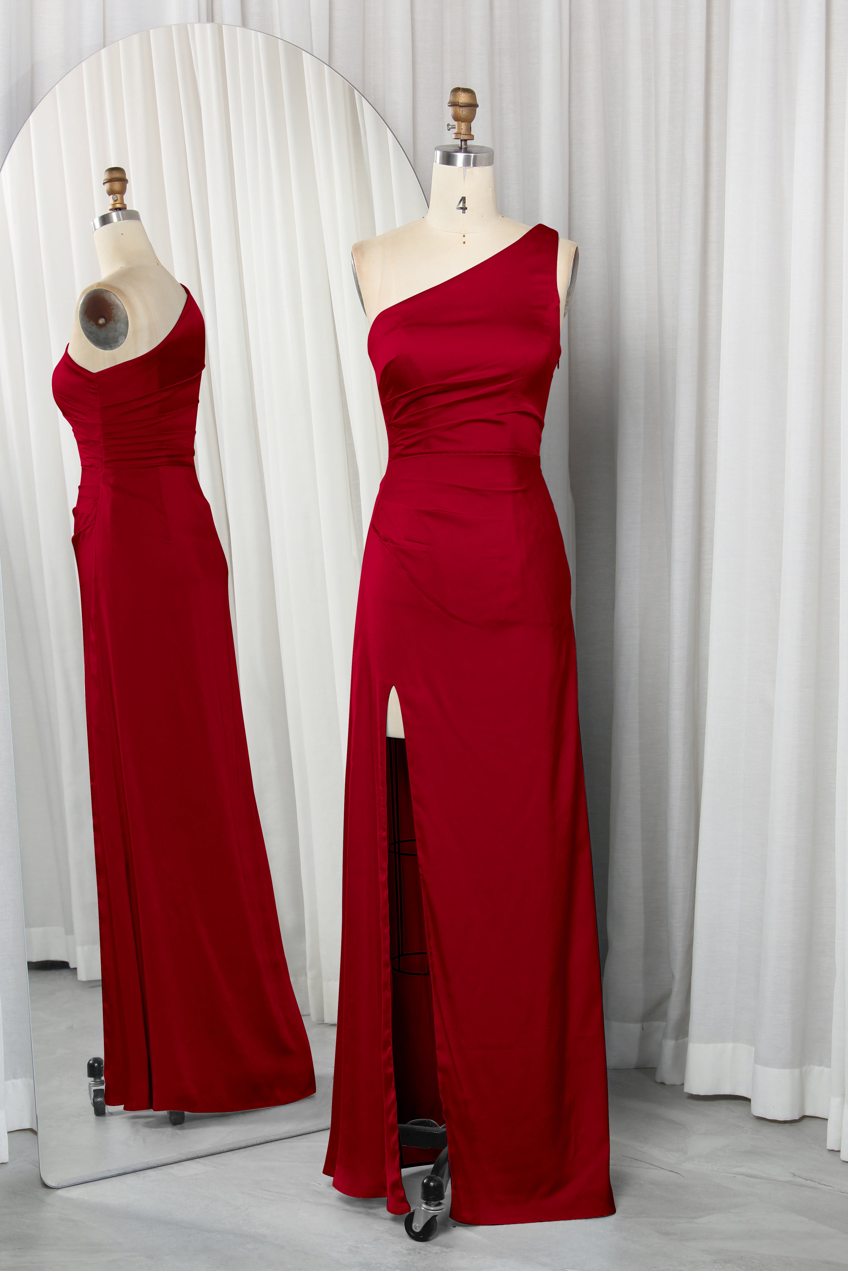 one-shoulder dress with a high slit displayed on a mannequin.