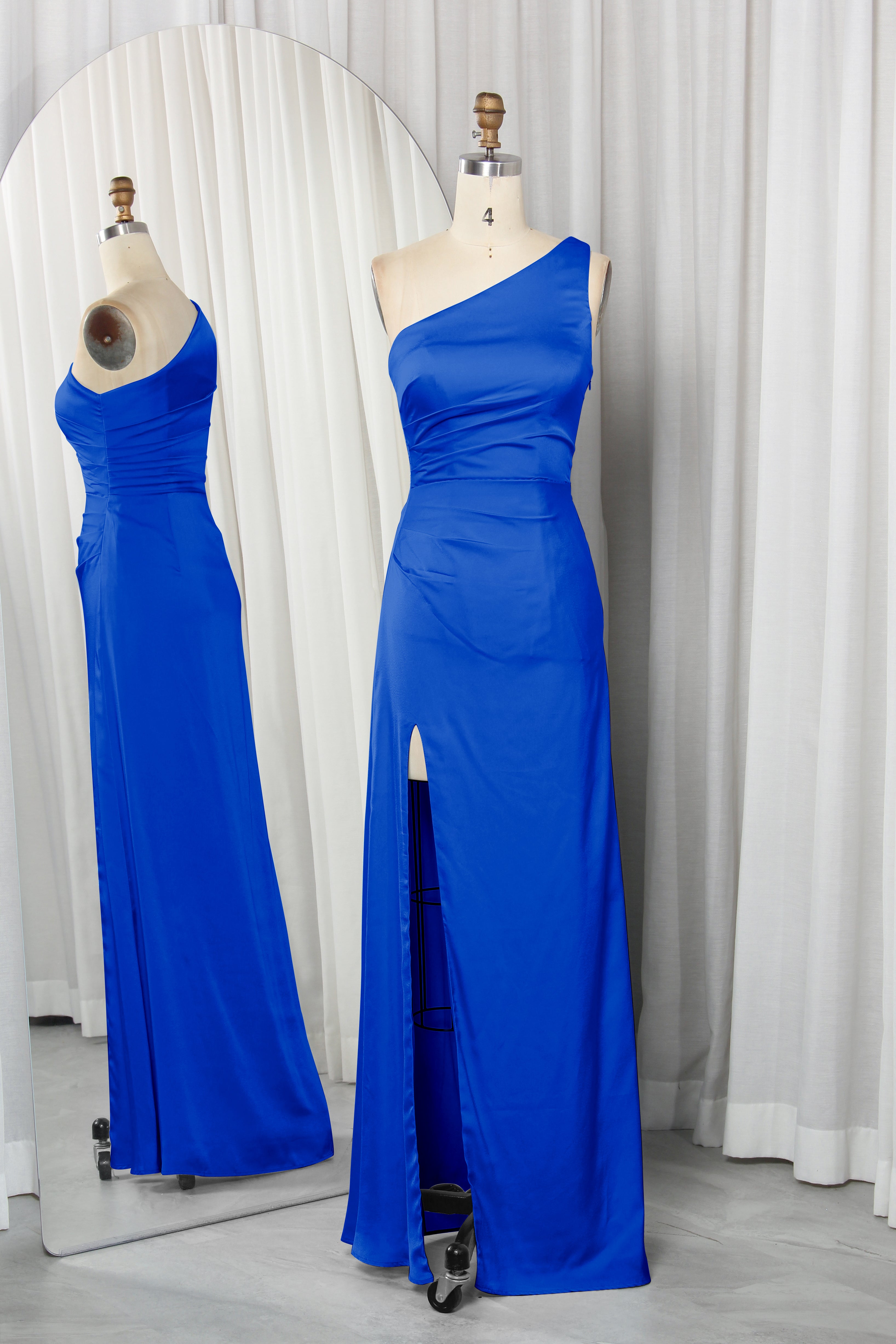 one-shoulder dress with a high slit displayed on a mannequin.
