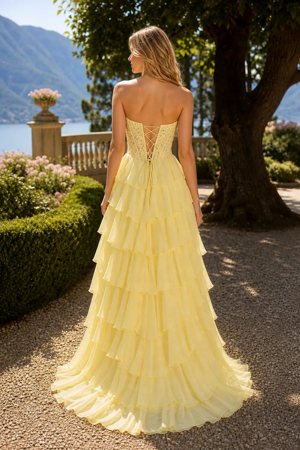 Yellow spaghetti strap tiered gown, open-back lace-up detail and layered ruffle skirt