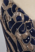 Navy and gold sequin mini dress with ornate swirl beading, close-up