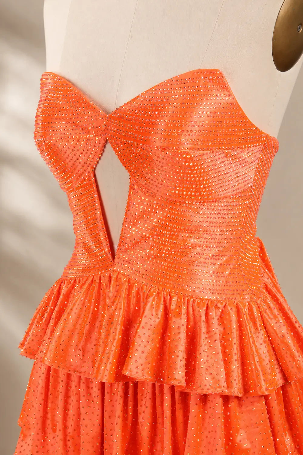 Orange sweetheart mini sequin dress with layered ruffle skirt, corset bodice