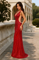 Red sequined sleeveless evening gown with V-neck, open back, and mermaid hem