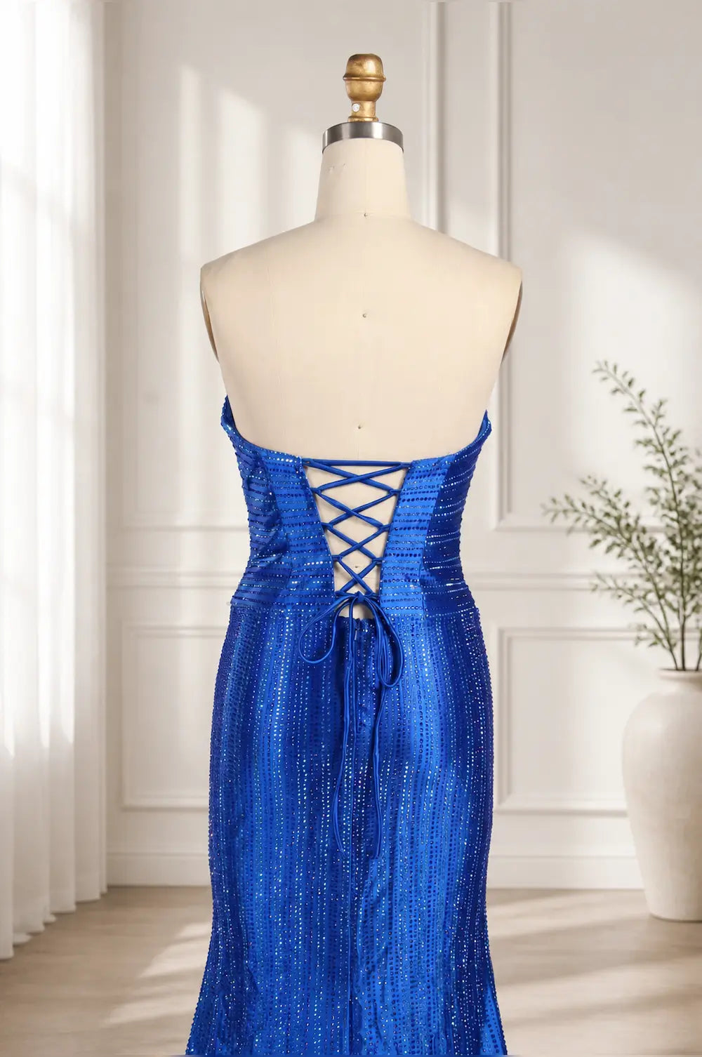 Royal blue sequin corset-style back with crisscross lacing on fitted dress