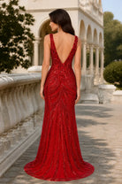 Red sequined V-neck evening gown with open back and fitted mermaid skirt