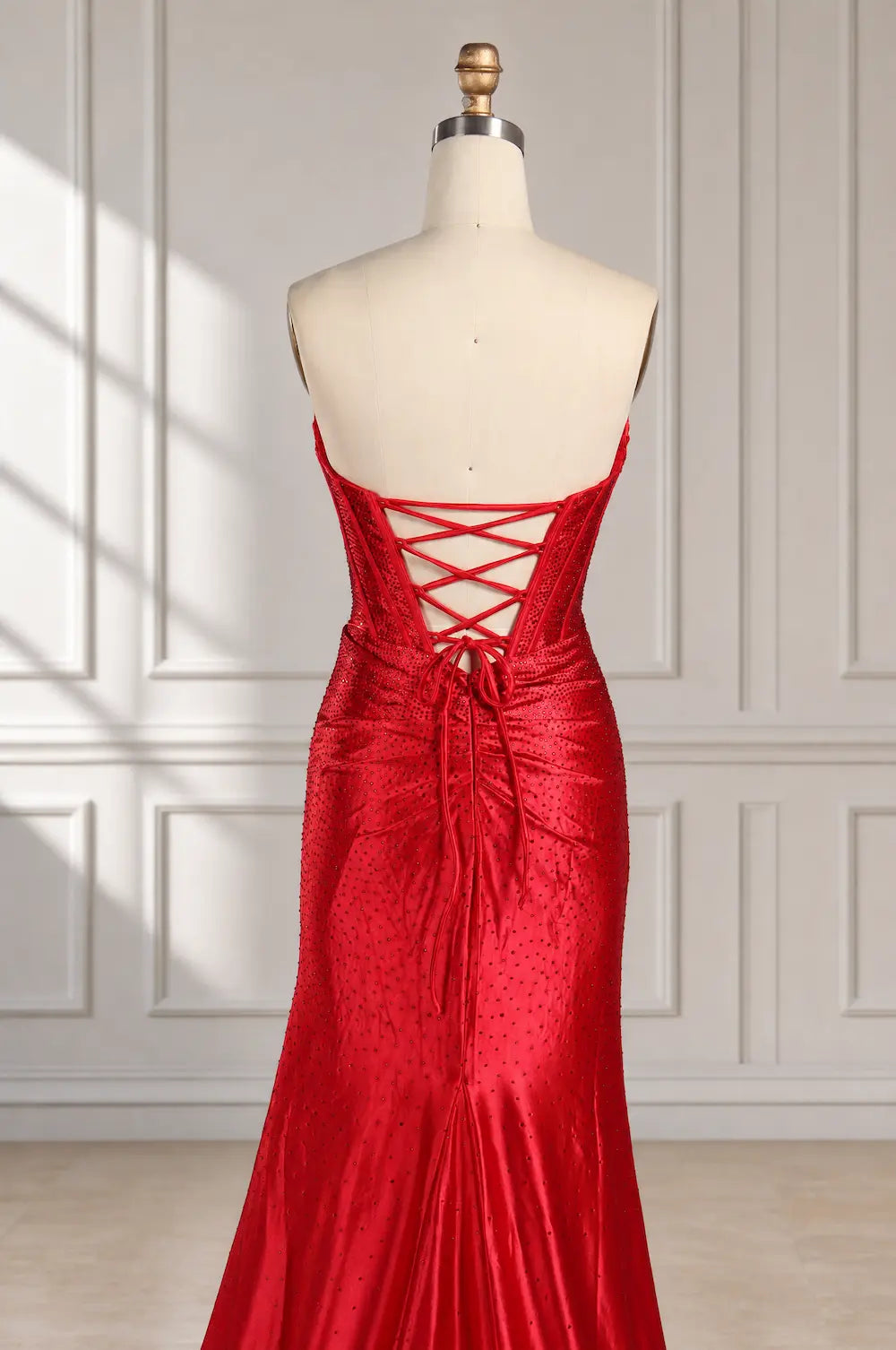 Red fitted evening dress with crisscross back lacing and high-sheen finish