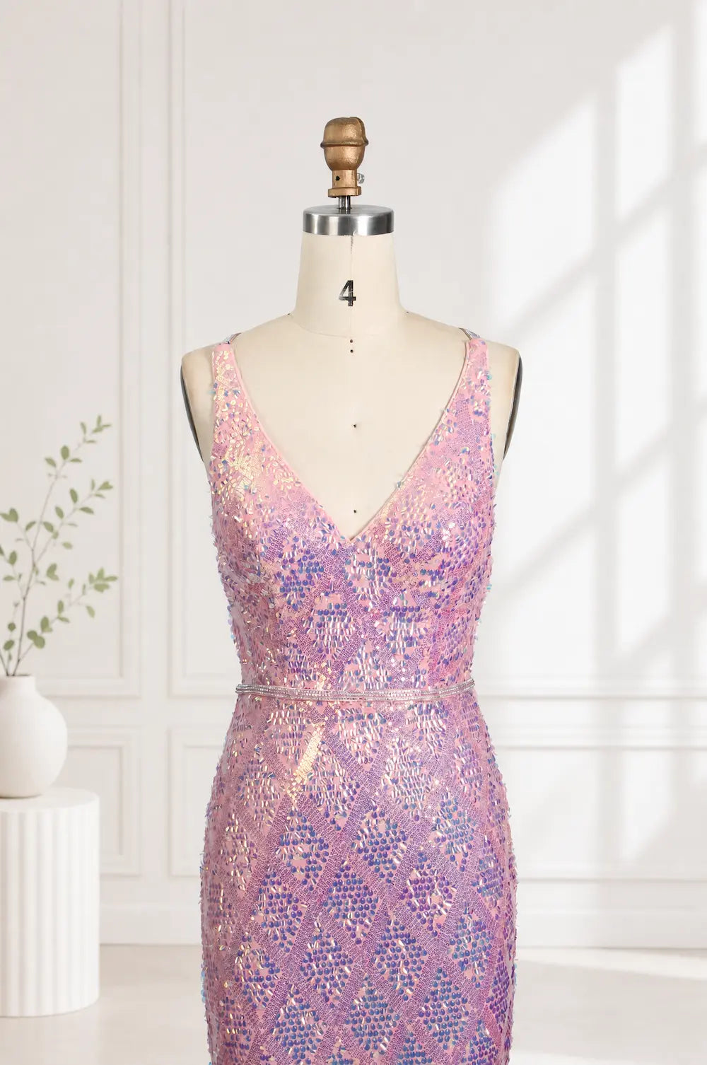 Iridescent pink sequin mermaid prom dress on mannequin with V-neck fitted bodice