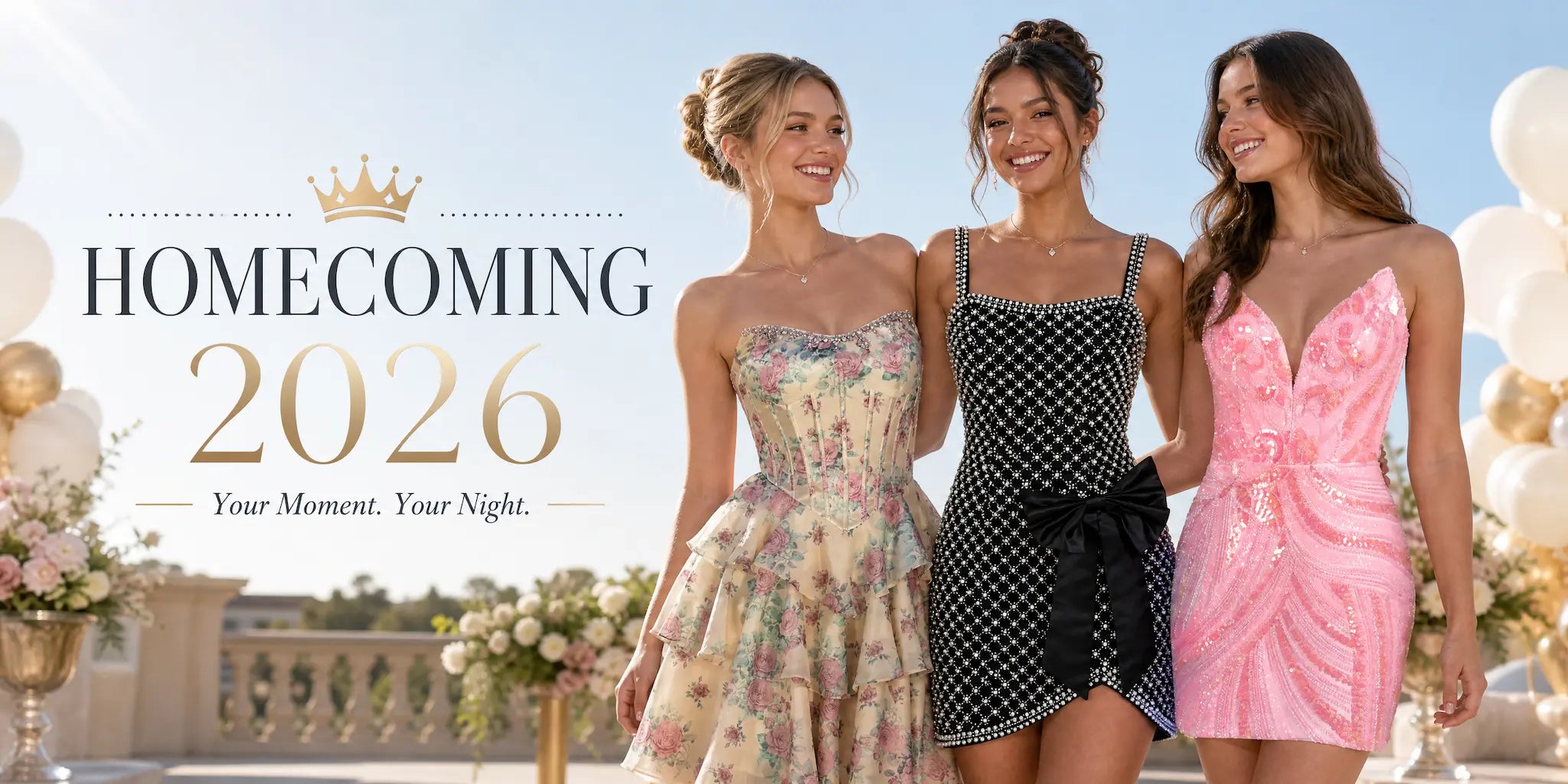 Homecoming 2026 promotional banner reading 'Your Moment. Your Night.' with a gold crown icon. Three smiling models pose outdoors against a blue sky with white balloons. From left to right: a model in a strapless yellow floral corset tiered dress, a model in a black embellished mini dress with a large bow, and a model in a bright pink sequin plunging V-neck dress.