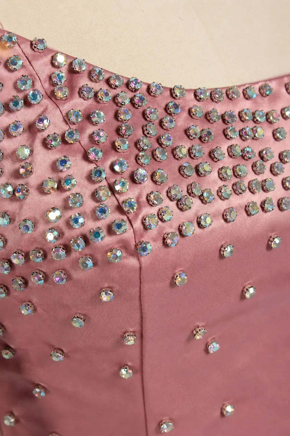 Pink sequin bodice with rhinestone embellishments and buttoned waist panel