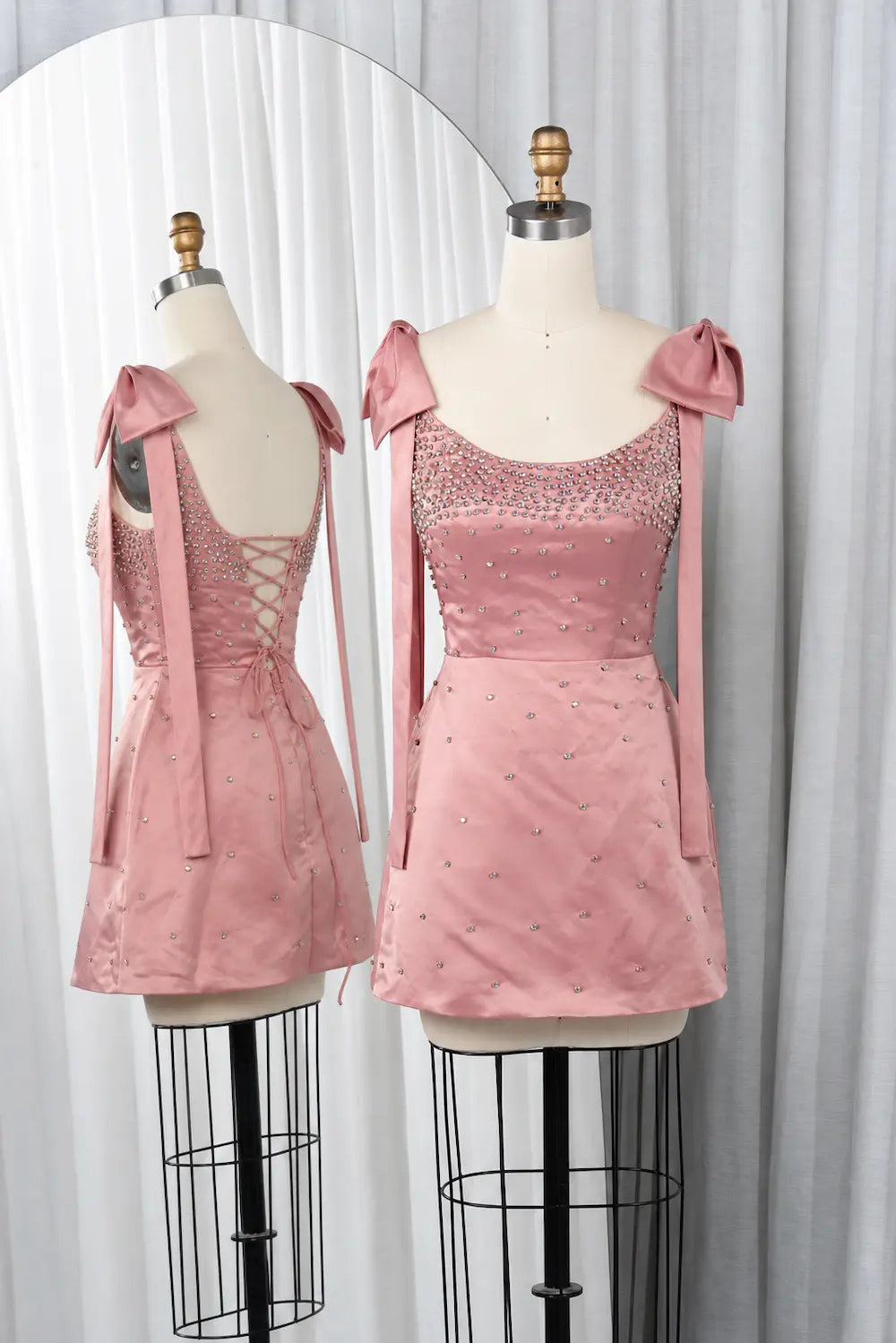 Pink sequin mini dress with sweetheart neckline and bow shoulder ties