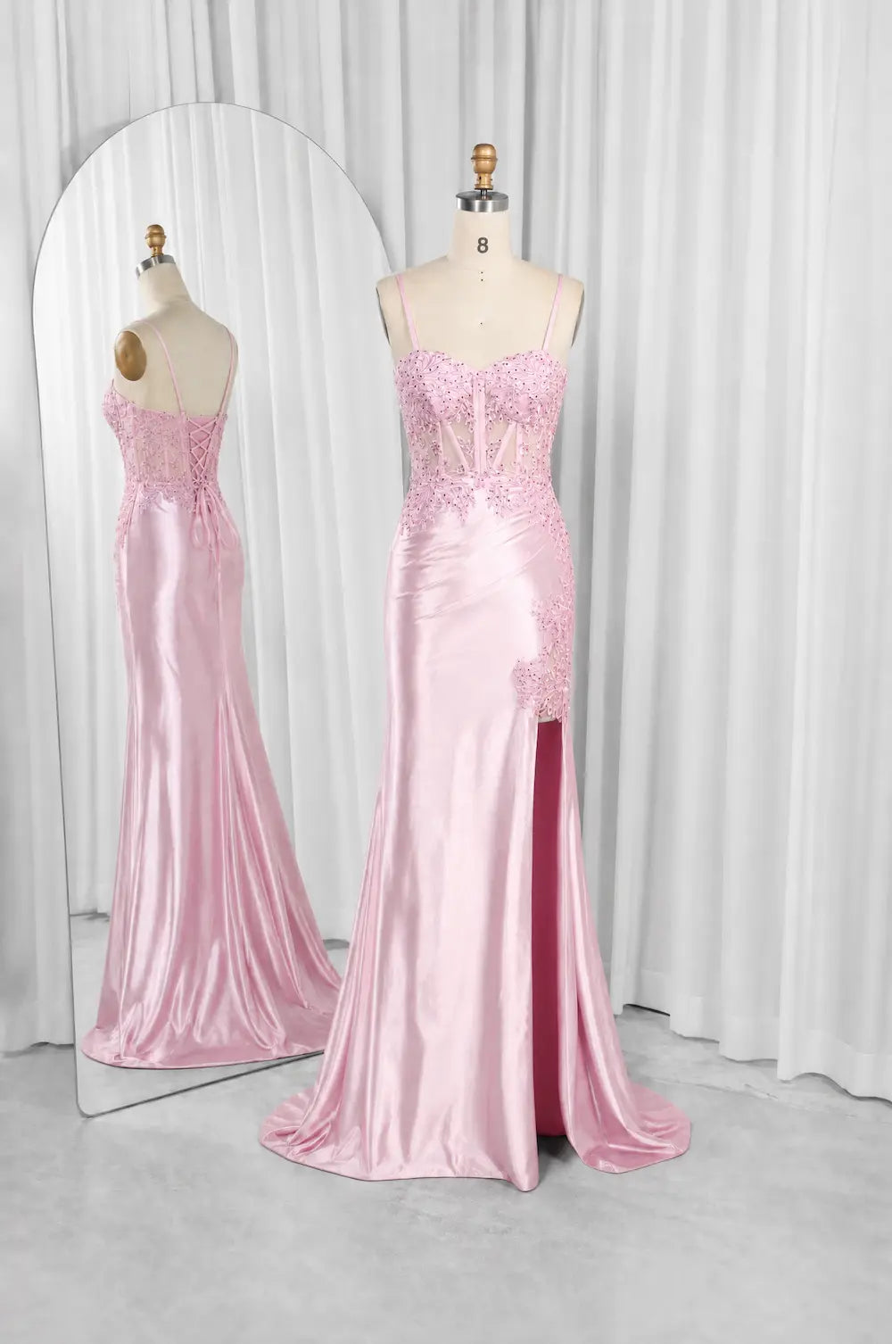 Pink embellished evening dress on mannequins, corset bodice, mermaid silhouette