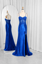 Royal blue evening gown on mannequin with lace corset bodice and thin straps