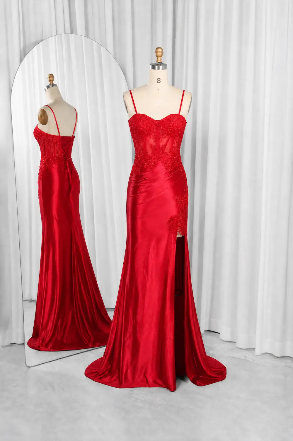Red mermaid formal dress with lace bodice, spaghetti straps, and draped skirt
