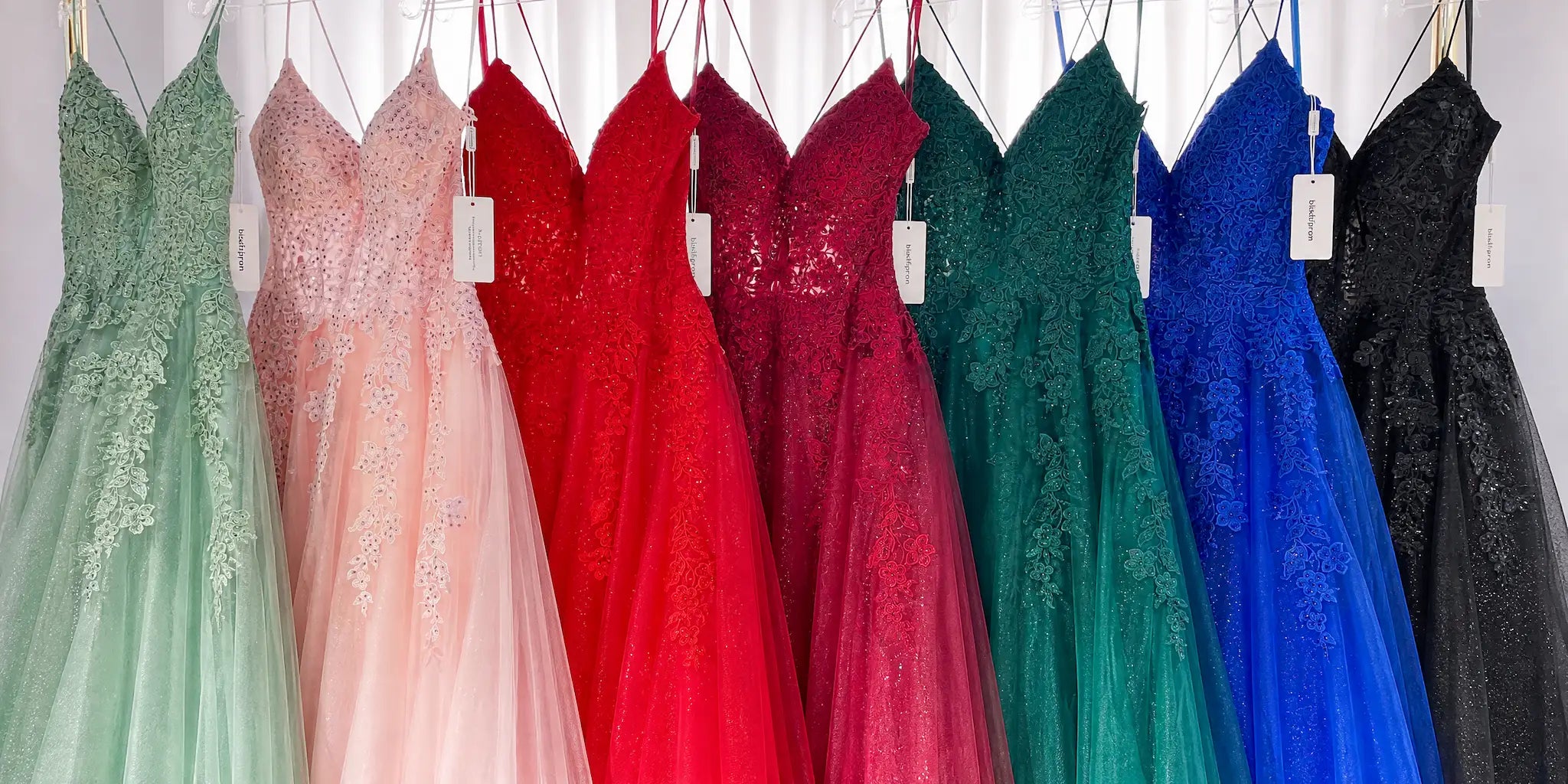 The Kadia prom dress collection by Blissful Prom, featuring various colors including sage green, pink, red, burgundy, emerald green, royal blue, and black glitter tulle gowns with lace bodices.