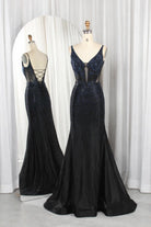 Navy rhinestone corset mermaid prom dress with open back and crisscross straps.