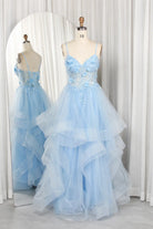 Blue spaghetti-strap tiered tulle prom dress on mannequin, 3D floral details