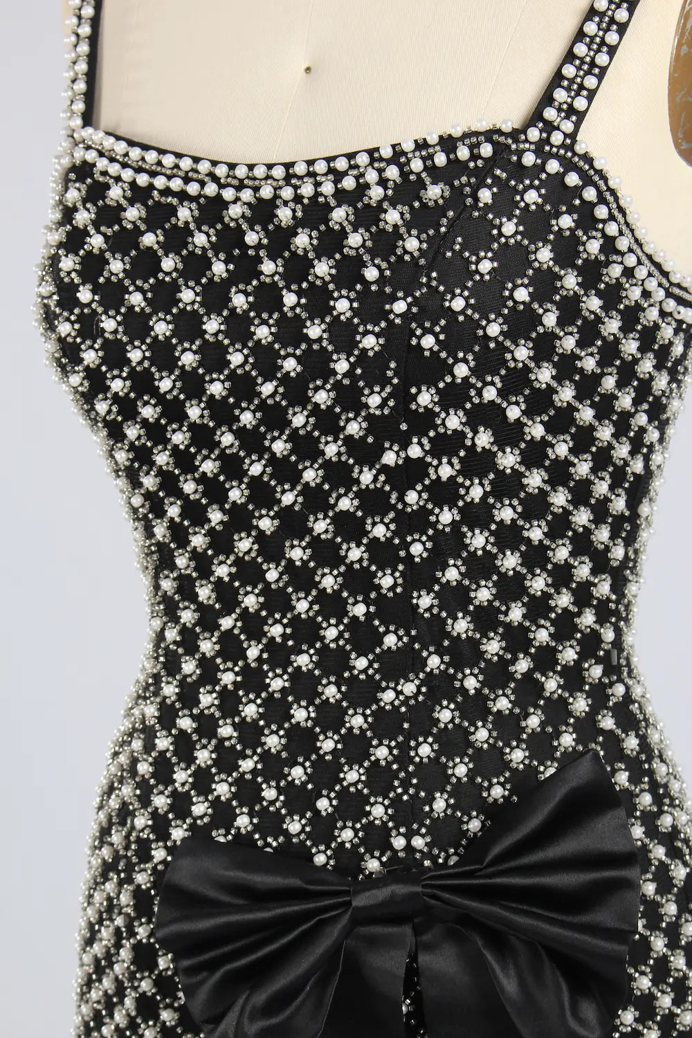 Black plus-size embellished mini dress with rhinestone star pattern and front waist bow