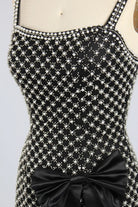 Black plus-size embellished mini dress with rhinestone star pattern and front waist bow