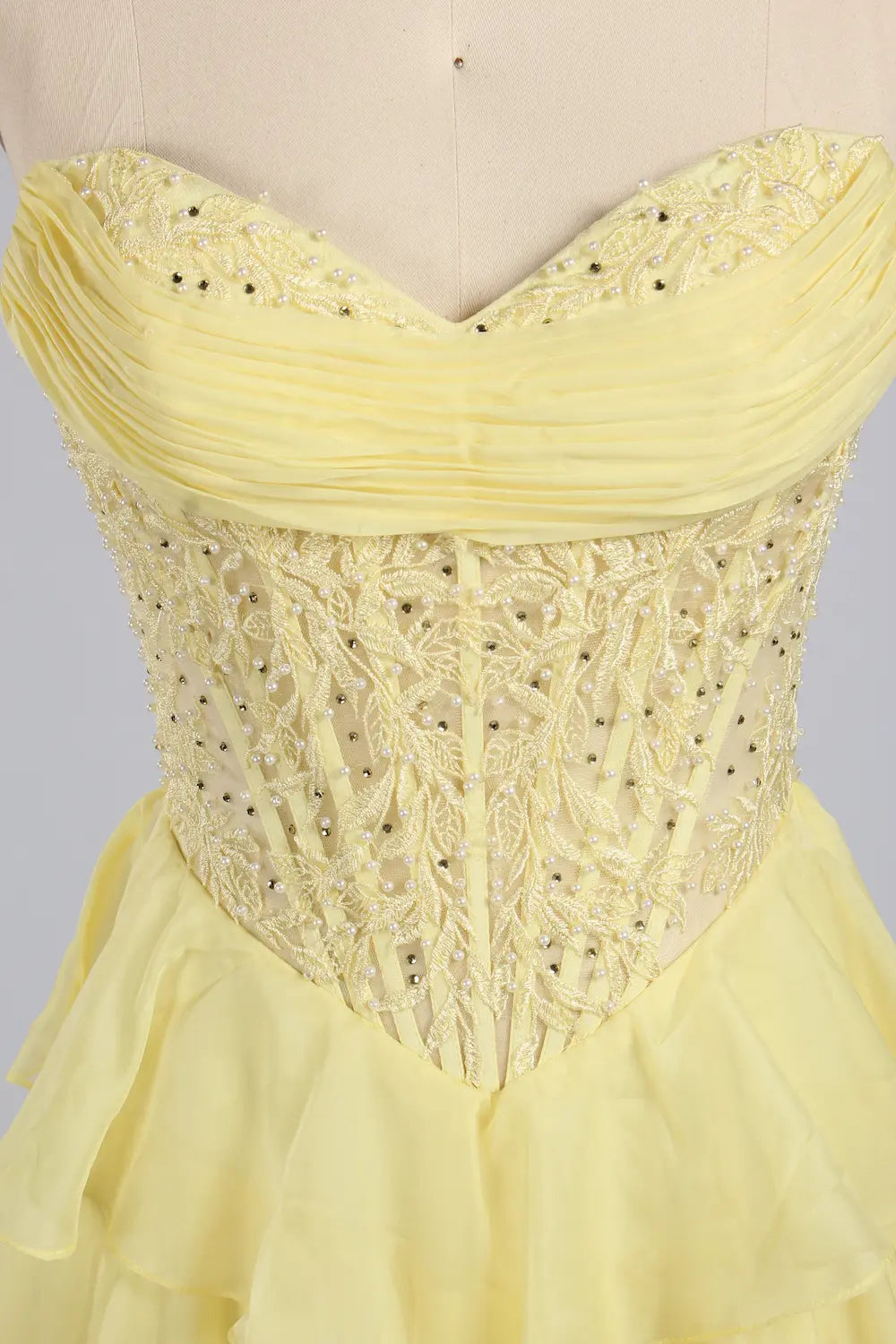 Yellow plus-size tiered ruffle gown with beaded corset bodice and sweetheart neckline