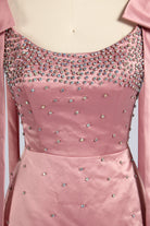 Pink plus-size satin cocktail dress with rhinestone-studded bodice and scoop neckline