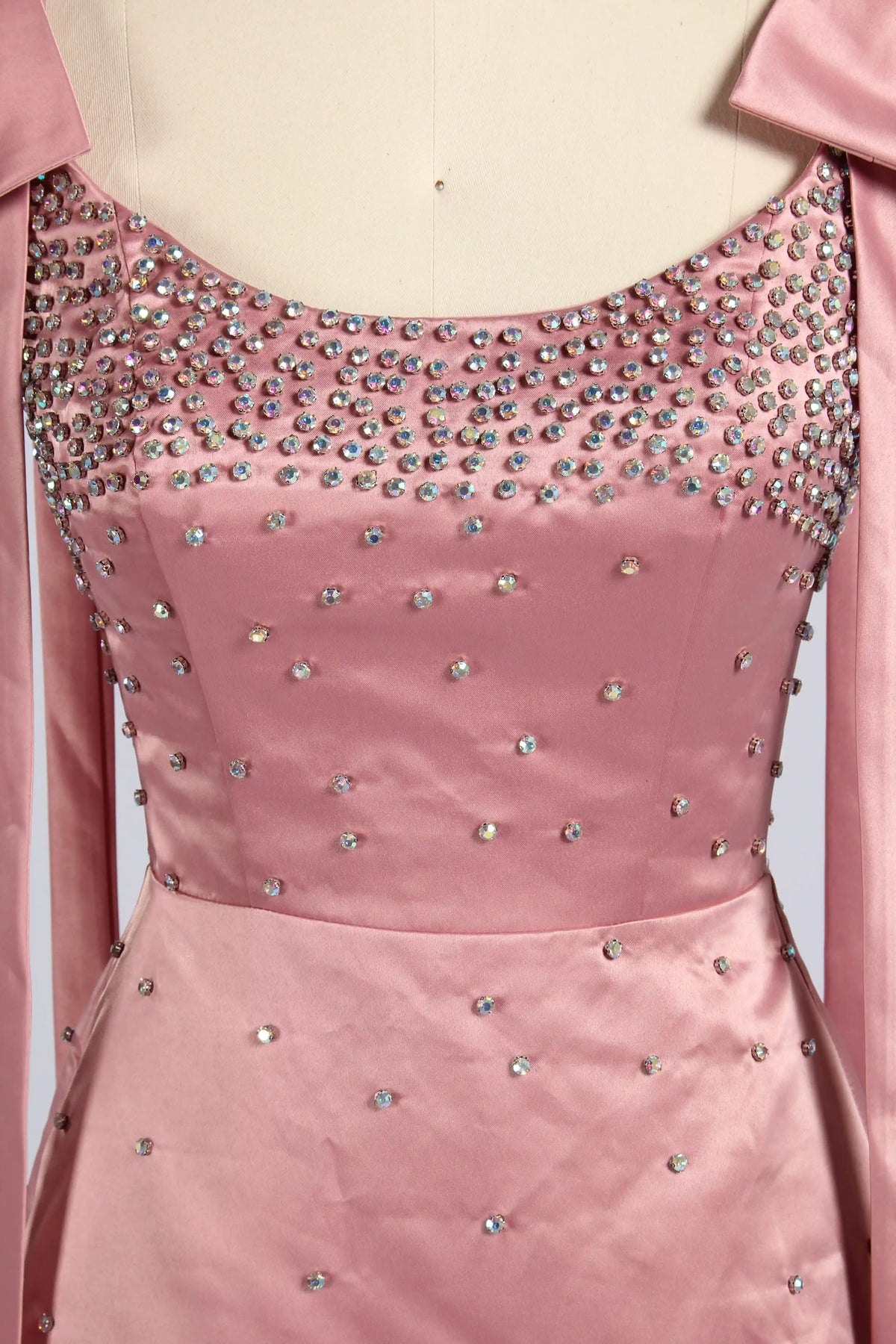 Pink plus-size satin cocktail dress with rhinestone-studded bodice and scoop neckline