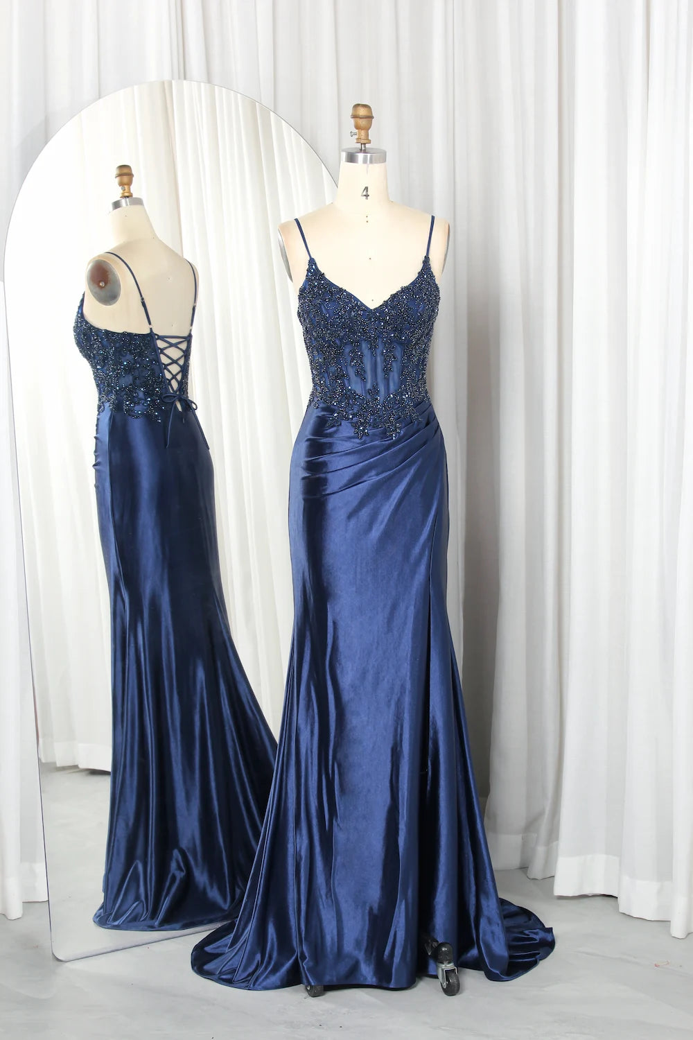 Navy beaded corset gown with lace-up back, full-length satin skirt on mannequin
