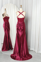 Wine mermaid gown on mannequin with beaded lace corset and ruched satin skirt