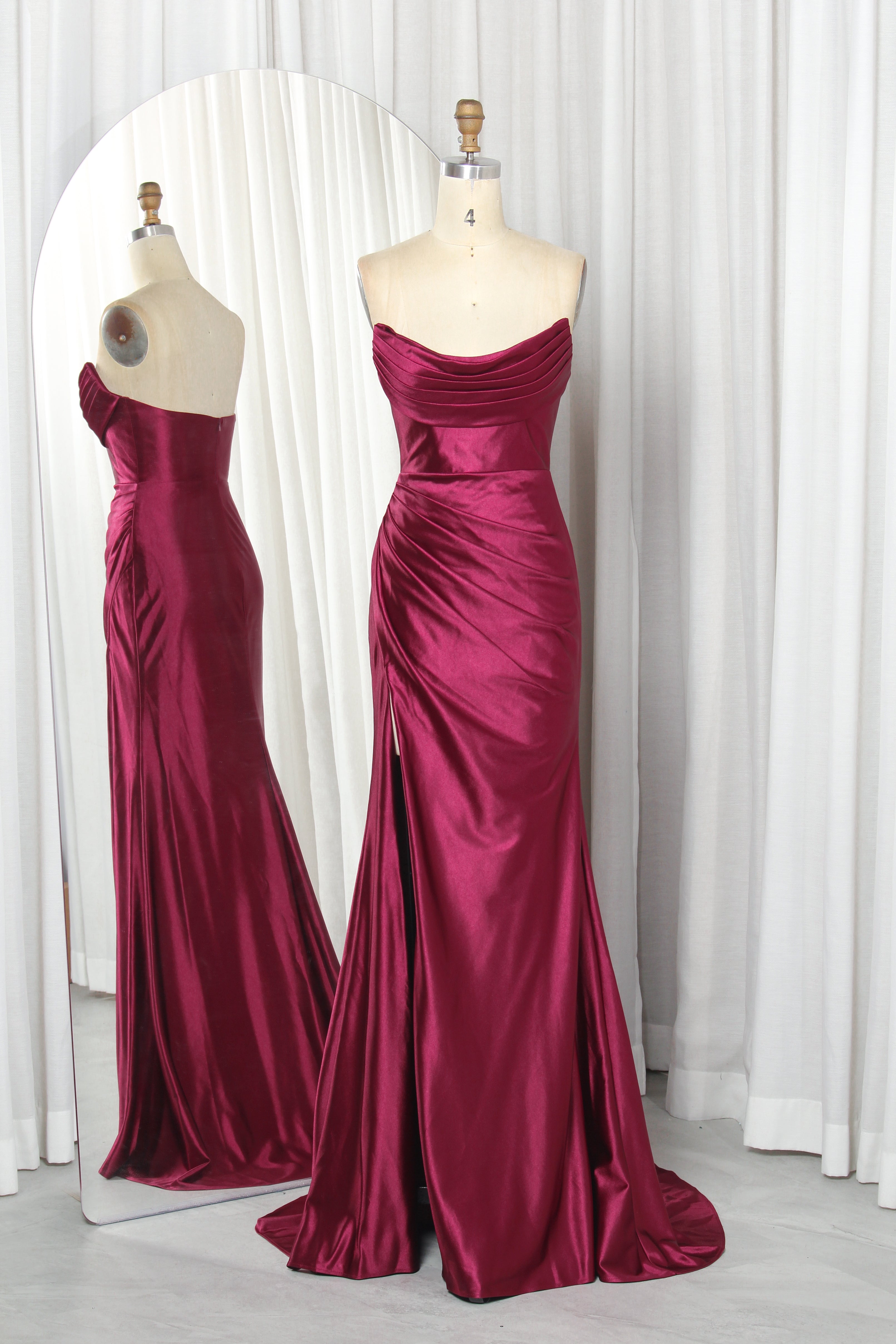 strapless satin dress with a draped bodice and high slit.