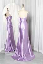 Lilac strapless satin mermaid prom gown on mannequin, draped bodice and long flared skirt