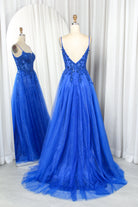 Blue corset-style prom dress on mannequin with spaghetti straps, glitter tulle skirt, open back