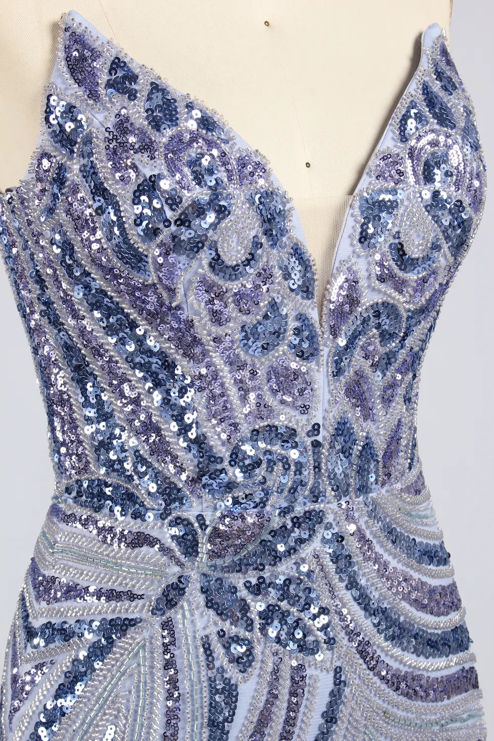 Close-up of blue and silver sequin V-neck bodice with ornate patterns
