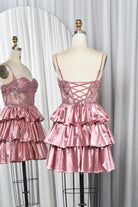 Pink sequin lace corset babydoll dress with crisscross tie-back and tiered satin ruffles