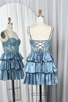 Dusty blue sequin lace corset babydoll dress with crisscross back straps and tiered ruffles