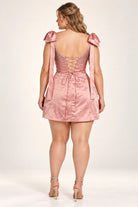 Pink plus-size satin dress with lace-up back and rhinestone sparkle; tie bow sleeves
