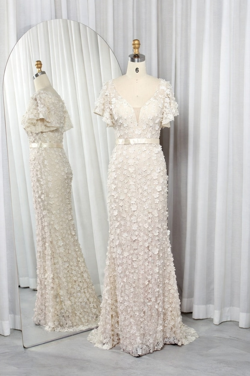 Champagne mermaid gown with floral appliques, fitted waist, and short ruffle sleeves