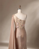 Champagne satin one-shoulder gown with 3D floral appliqués and long draped sleeve