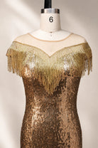 Gold sequin gown with fringe off-shoulder neckline on mannequin