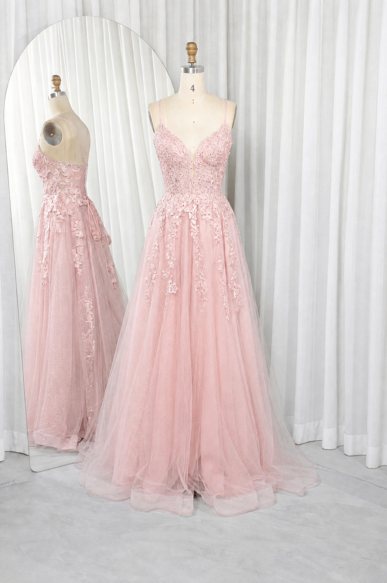 Pink A-line prom dress with lace bodice, spaghetti straps, and tulle skirt