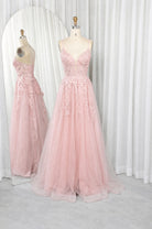 Pink A-line prom dress with lace bodice, spaghetti straps, and tulle skirt