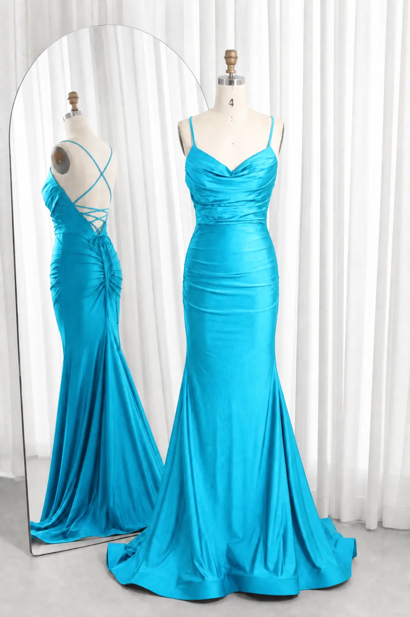 Turquoise satin cowl-neck ruched mermaid prom dress with spaghetti straps and flared hem.
