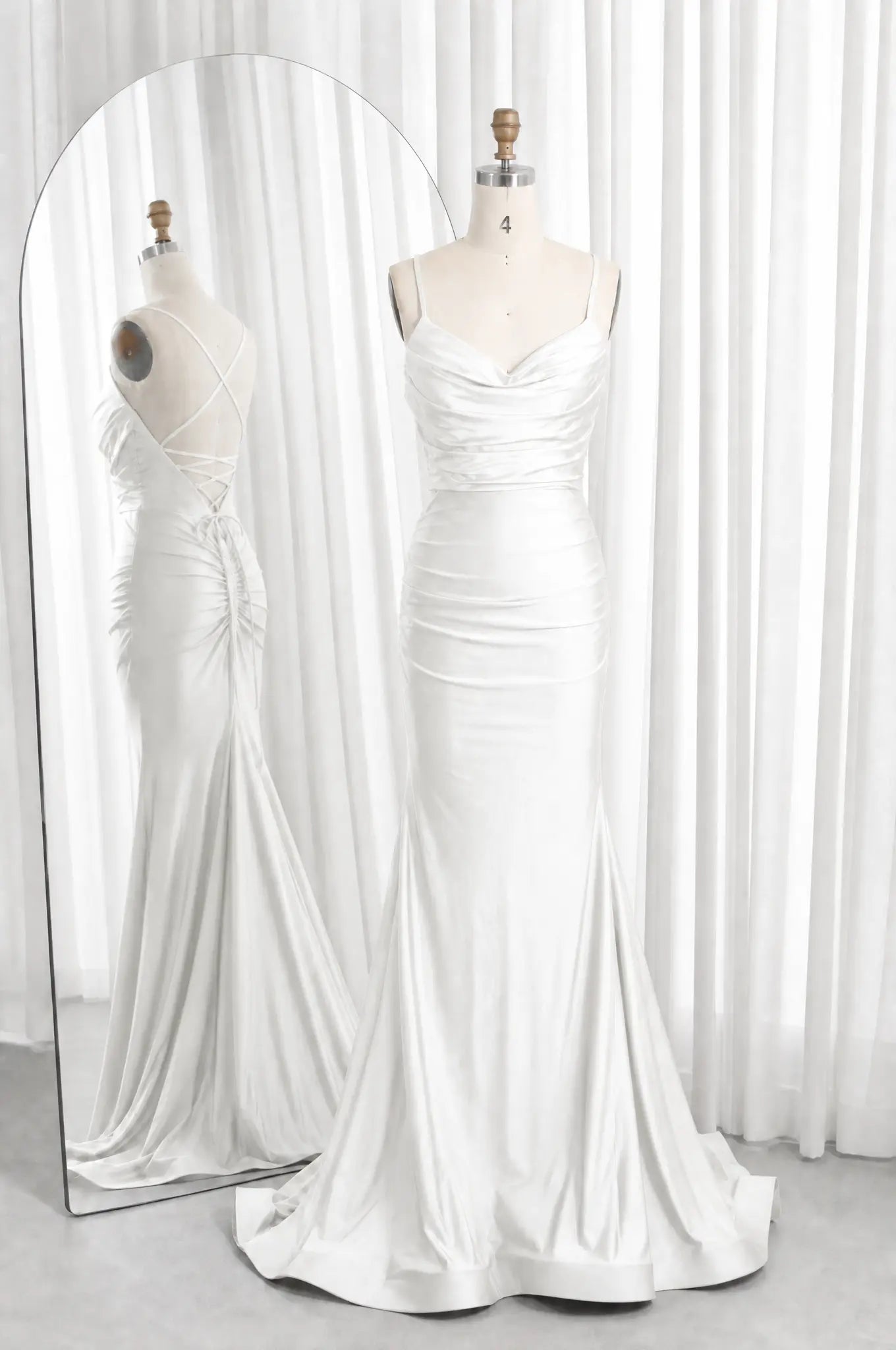 White satin cowl-neck ruched mermaid prom dress with spaghetti straps and flared hem.