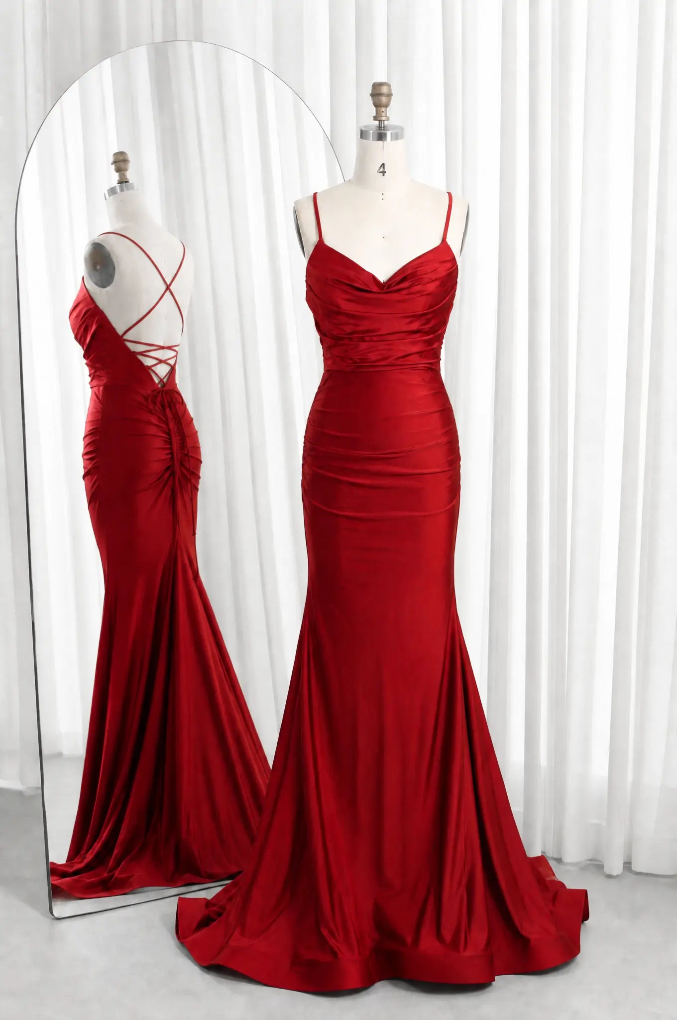 Red satin cowl-neck ruched mermaid prom dress with spaghetti straps and lace-up back.