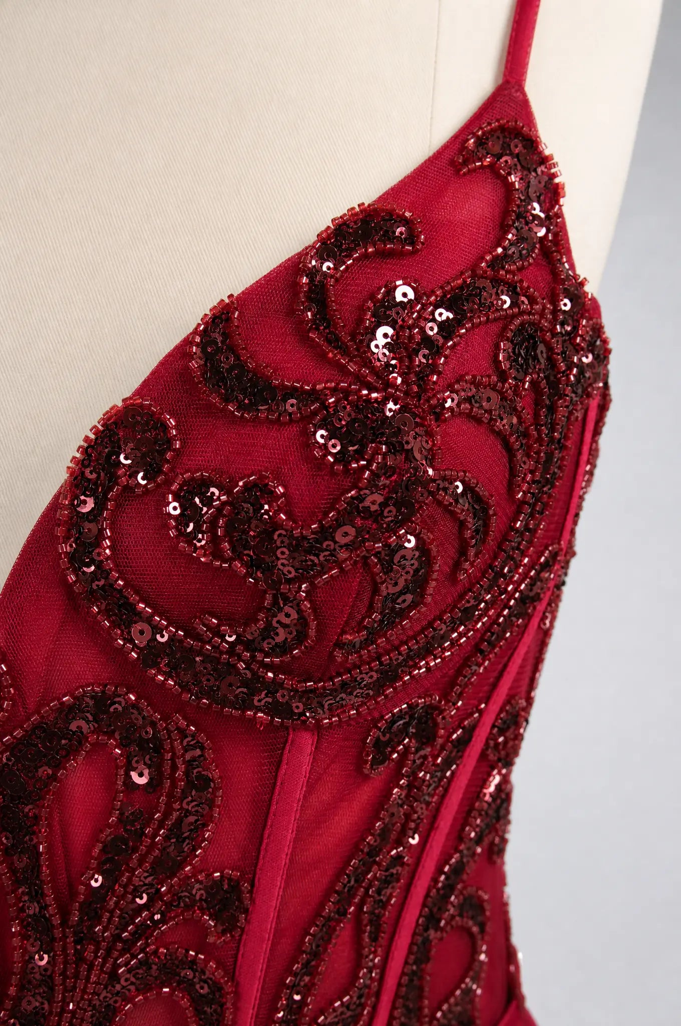 Sweetheart corset prom dress in dark red with ornate sequin lace detailing.